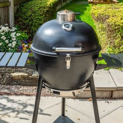 A Bar-Be-Quick 21-inch Steel Kamado barbecue with a lid and two shelves on a patio