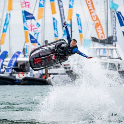 Man on a jet ski with boats in the background