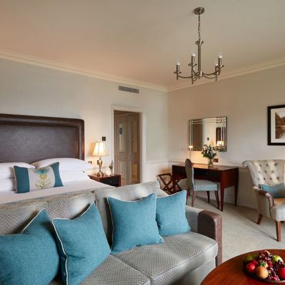 Image of a bedroom in a Macdonald Hotel, with a sofa and coffee table 