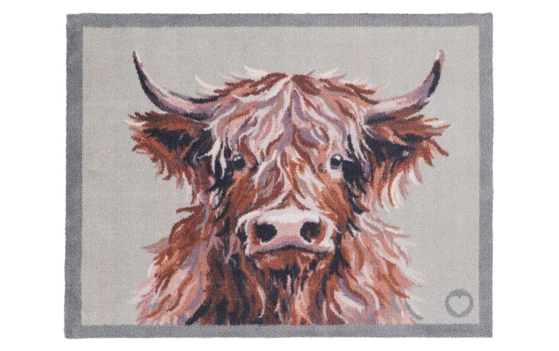 A Hug Rug doormat with a Highland Cow design