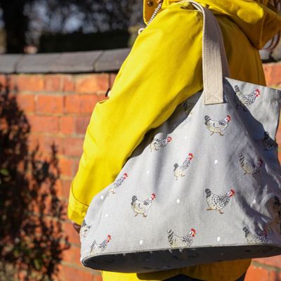 A lady in a yellow jacket with a Sophie Allport bag on her shoulder