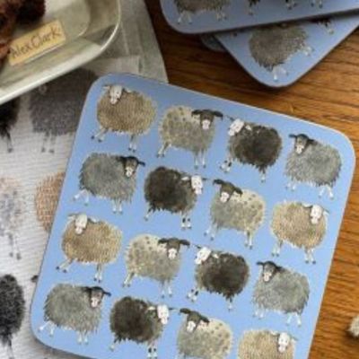 A set of pale blue drink coasters with a quirky sheep design