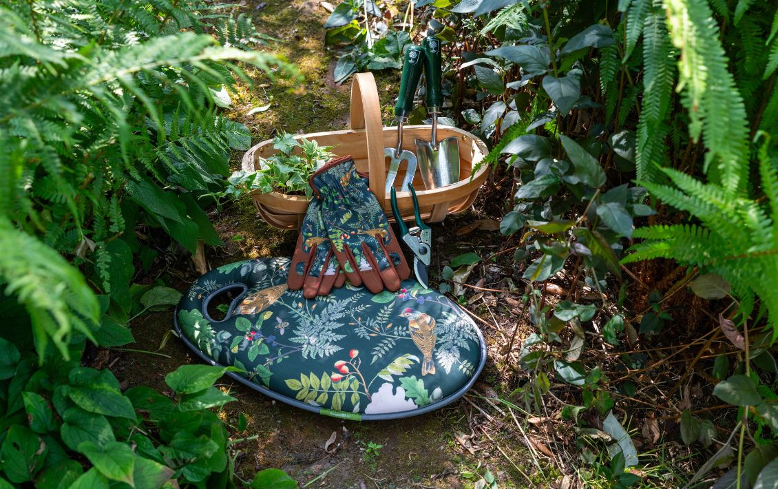 The Woodland Wonders collection of gardening tools from Burgon and Ball in a garden setting